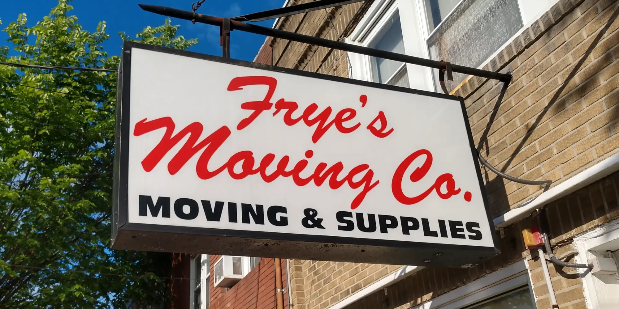 Frye's Moving Co. outdoor signage on sunny day.
