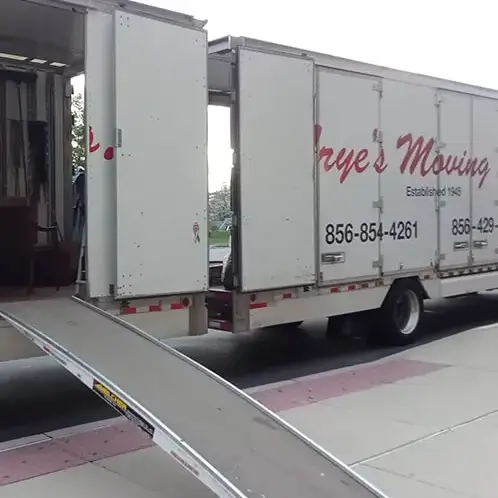 Frye's Moving truck with open ramp and visible company details.
