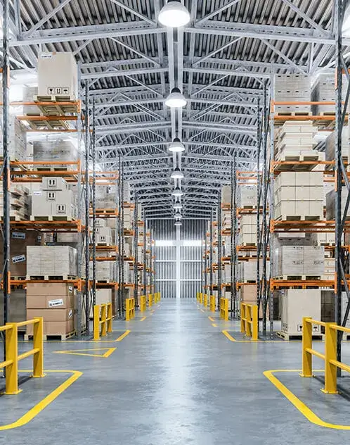 	Modern warehouse interior with rows of shelves and boxes.