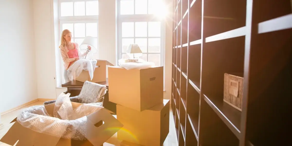 Woman unpacking in sunlit new home.
