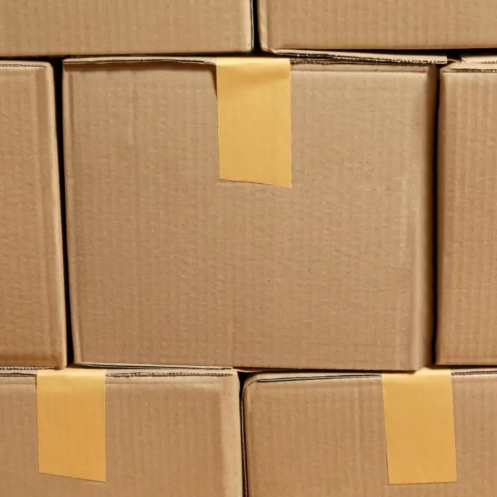 Stacked cardboard boxes with adhesive labels.